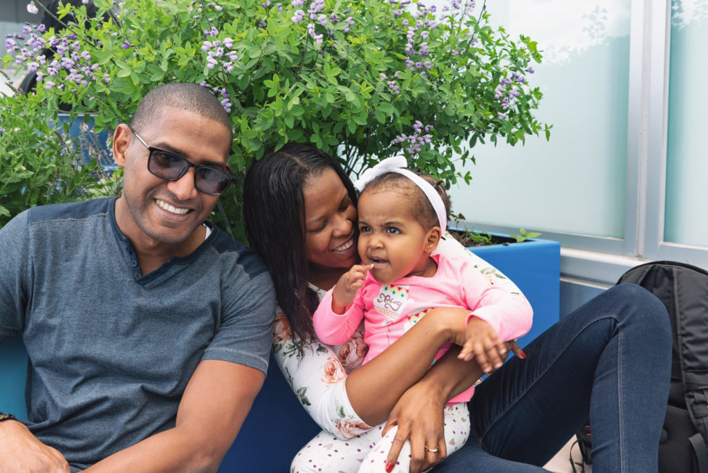 little girl with cdh sits with her parents