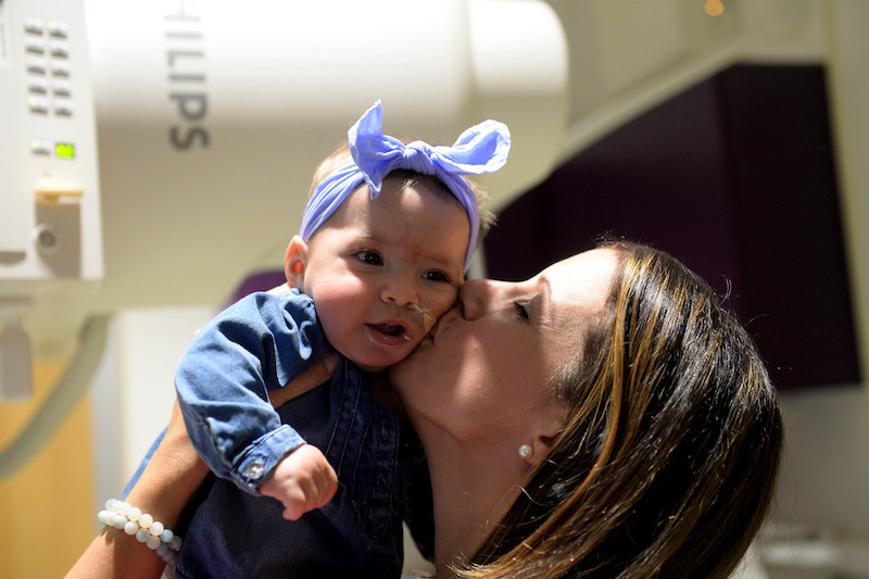 mom holds her aspirating baby