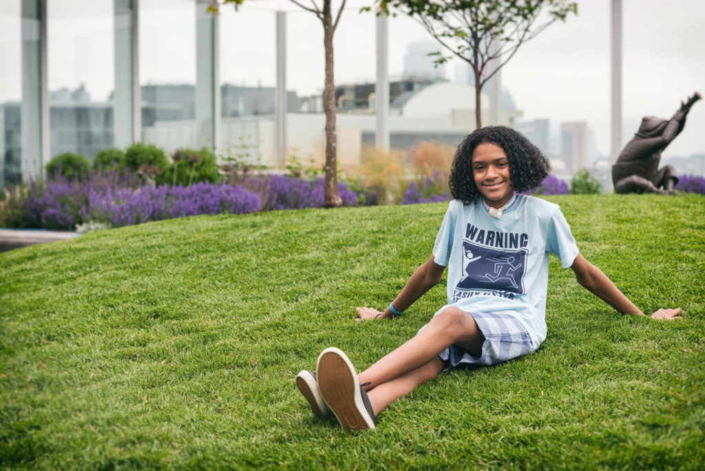 chase sits on the grass