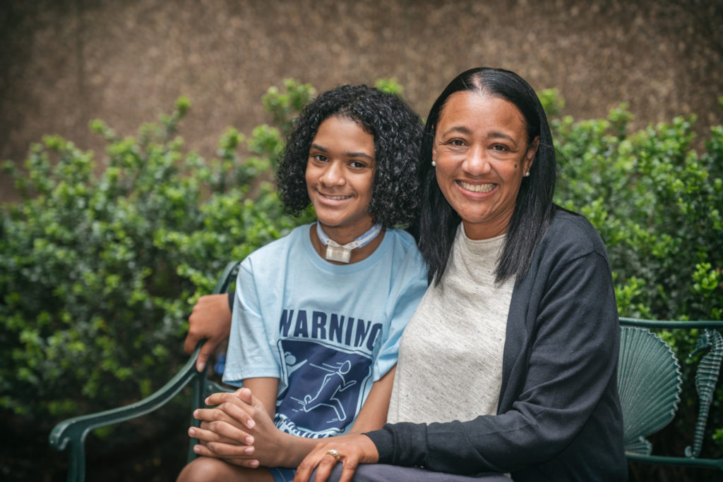 boy with esophageal damage poses with his mother
