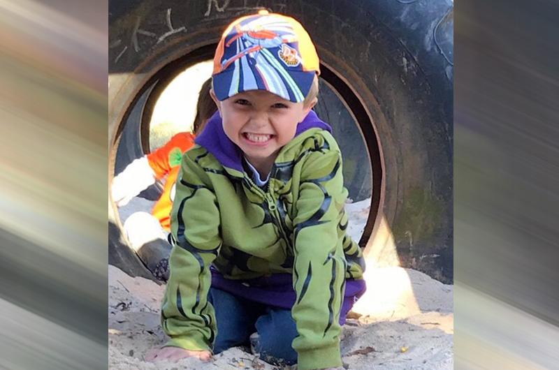 boy with esophageal atresia plays at the playground