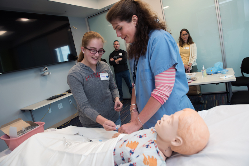A nurse demonstrates the pain-free IV system on a mannequin in the simulation lab for a patient scheduled for spinal fusion surgery.