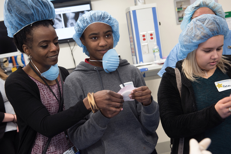 Patients and their parents look at the padding that will be used when they have spinal fusion surgery.