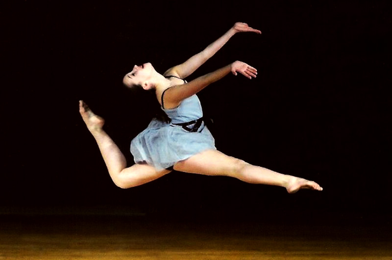 Photo of Alana, who had hip dysplasia, leaping through the air as a young dancer.