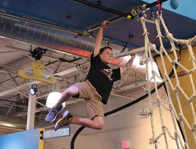 Gavin, who has Crohn's disease, during a Ninja warrior competition.