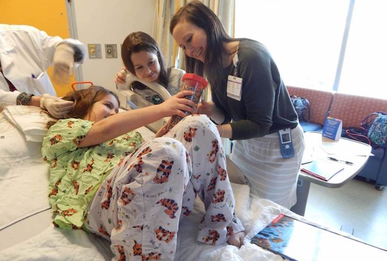 Andrea Lerude, a child life specialist, distracts a patient during a procedure.