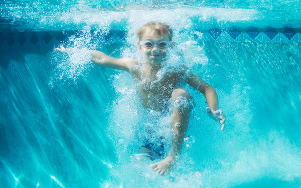 Boy swimming under water