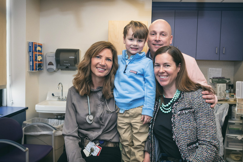 boy with tracheobronchomalacia poses with his parents and nurse