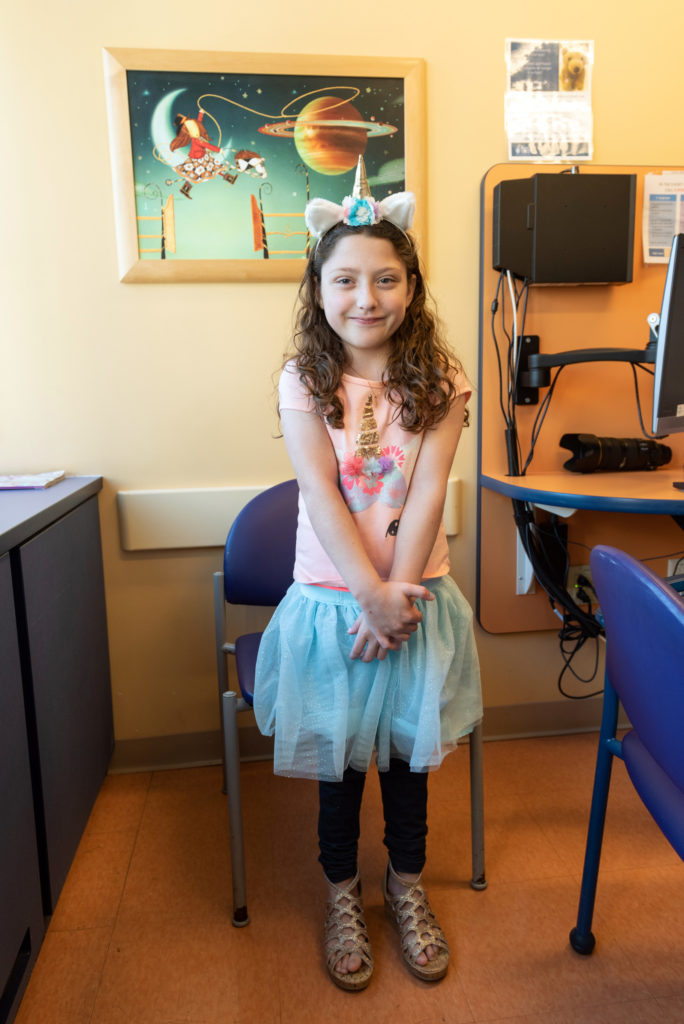 ava poses in an exam room