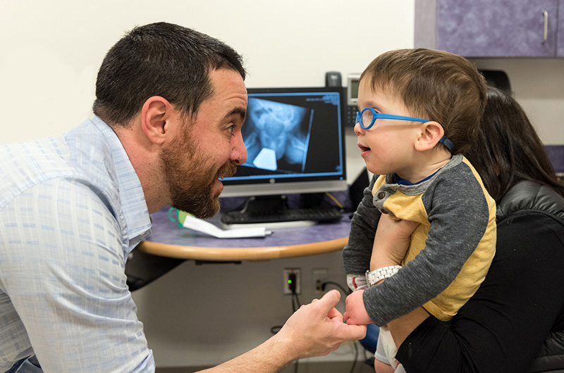 little boy visits with his doctor while receiving stroke care