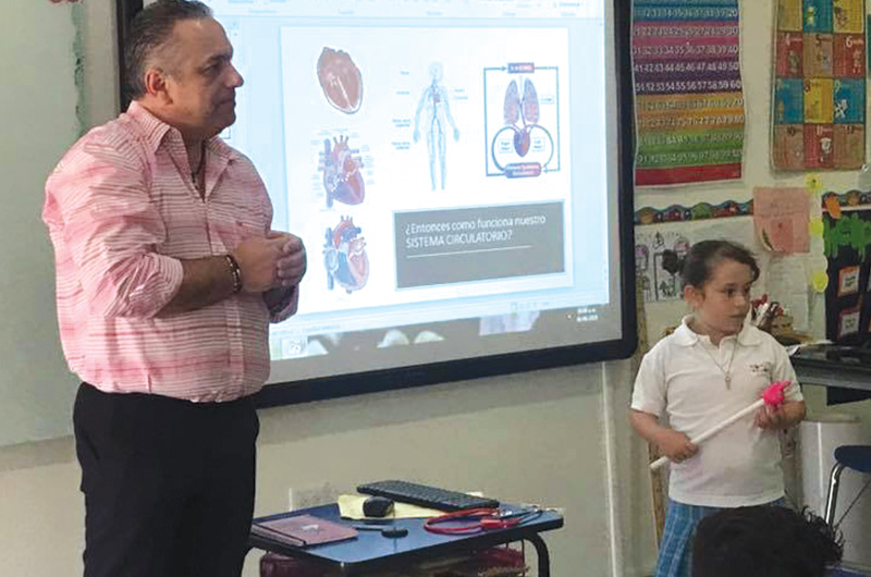 Regina and her father giving a presentation about HLHS