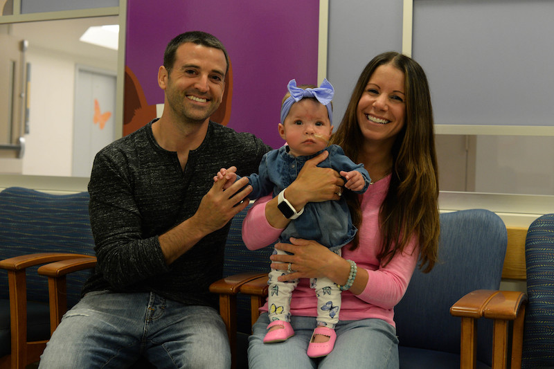 aspirating baby and her parents