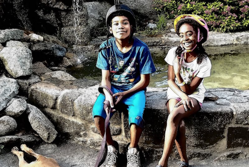 Jasmine, who had surgery for a Pott's puffy tumor, takes a break from a bike ride with her older brother Jayden.