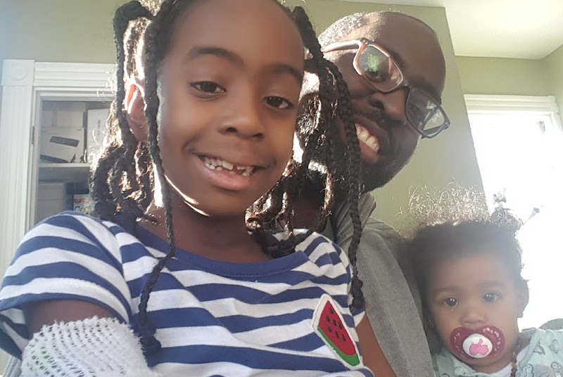 Jasmine, who had surgery for a Pott's puffy tumor, poses with her dad and younger sister.