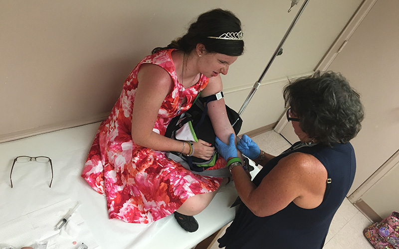 Morgan, who has hemophilia, gets an infusion with the help of her mother.