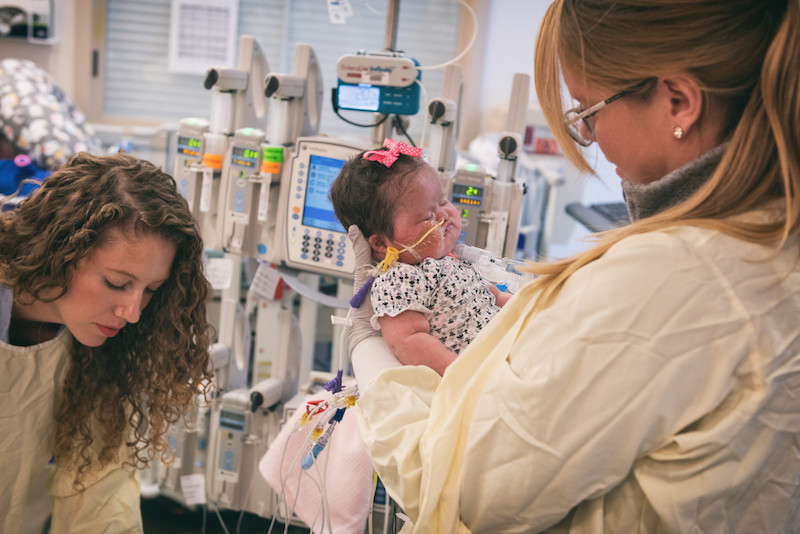Members of the CICU team care for an infant.