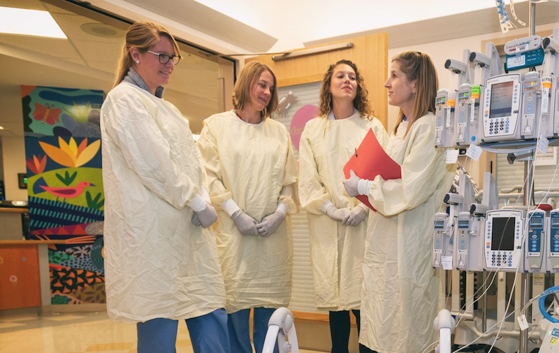 Team members in the CICU discuss a patient