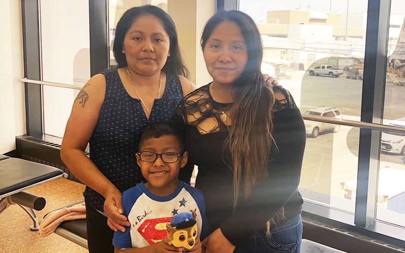 Ervis, who has Fanconi anemia, poses in the hospital with his aunt and mom.
