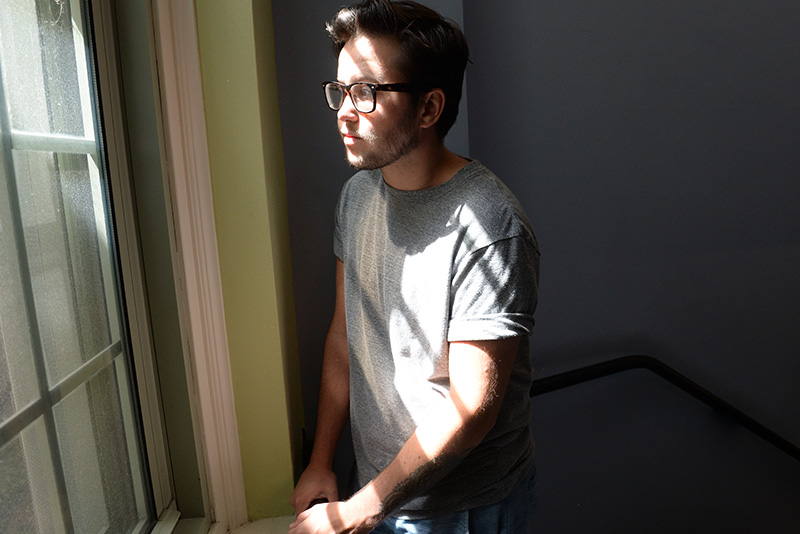 trans boy looking out of a window