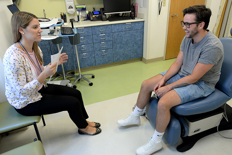 smiling trans patient talks to his PA