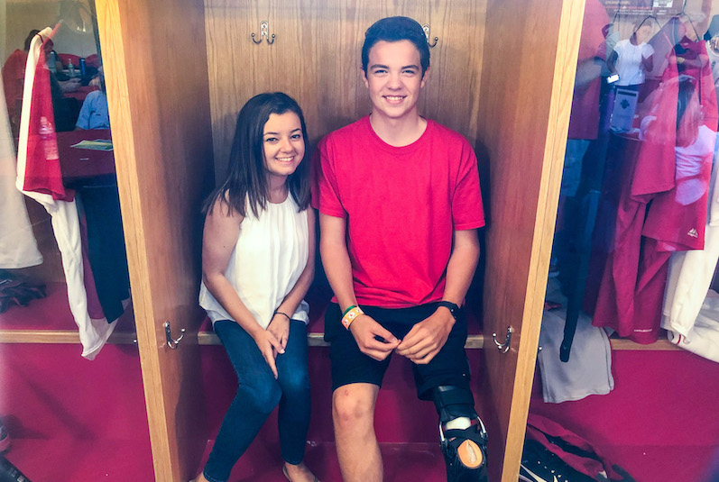 Gabbi, who survived cancer, sits with her friend Camden at spring training camp.