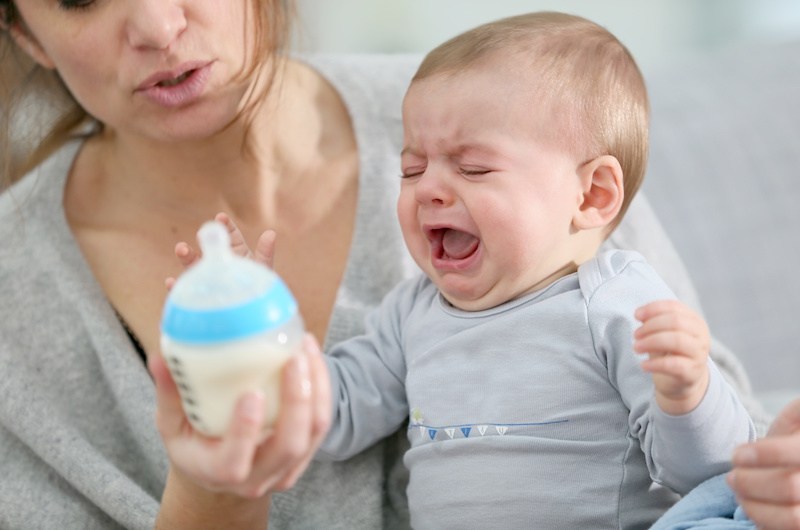 Baby crying, while mom tries to soothe