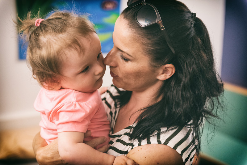 Sophie, who has SMA type 1, gets a hug from her mom