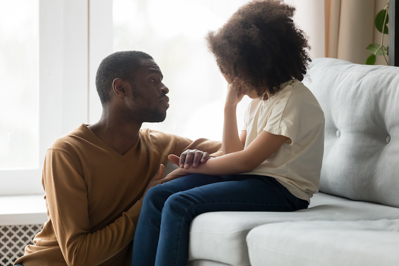 father comforting child with chronic pain