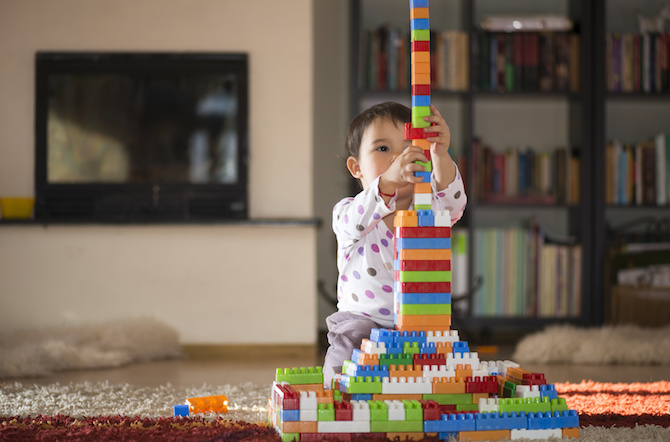 Child playing with stacking toy