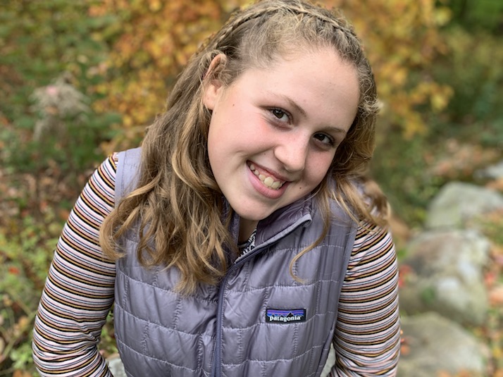 Lily, who received a liver transplant, smiles at the camera.