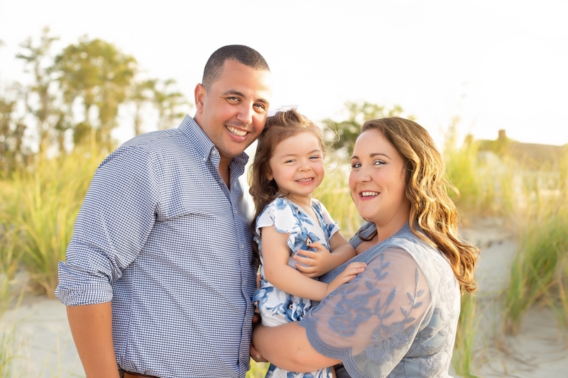Amelia, who had surgery for epilepsy, at the beach with her mom and dad