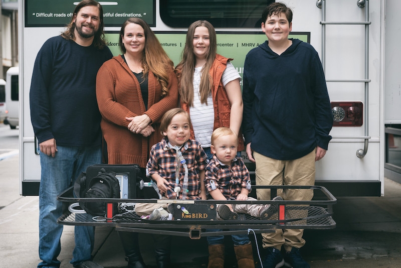 Noah, who had a biventricular repair, poses with his family.