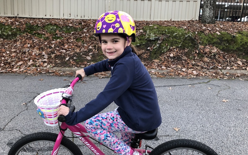 Jane, who had acute flaccid myelitis, on her bike.