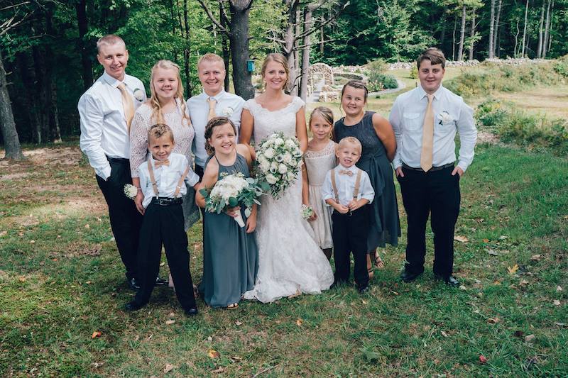 Maria, who was born with congenital scoliosis, poses with her siblings at her oldest sister's wedding.