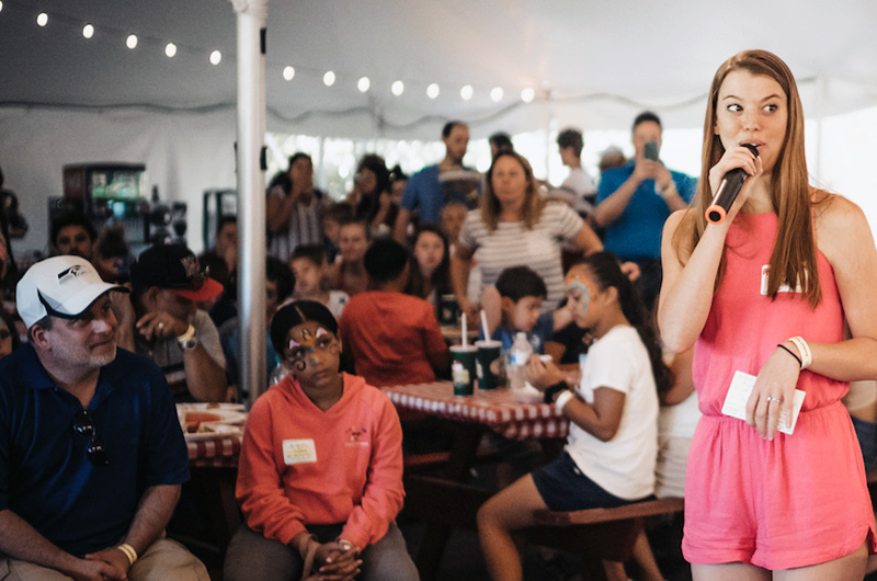 Woman addresses patients at Transplant Family Dayand families at celebration.