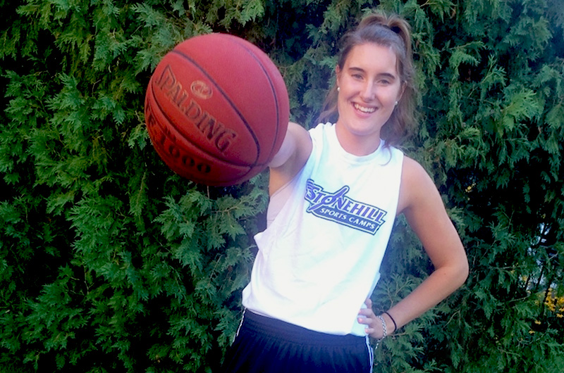 Kristen, who had surgery for her seizures, palms a basketball