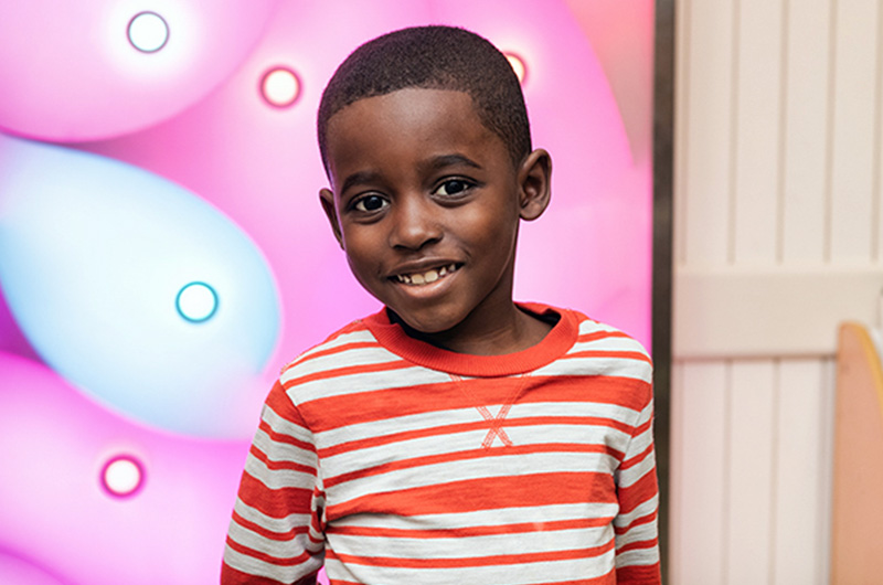 Lamarcus, who has sickle cell disease, smiles for the camera during a hospital visit