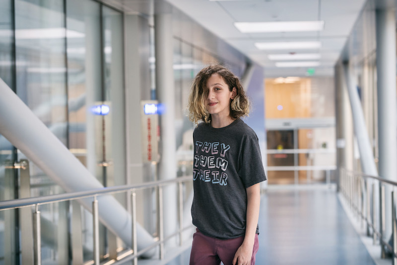 leven shows off their t-shirt with gender-neutral pronouns