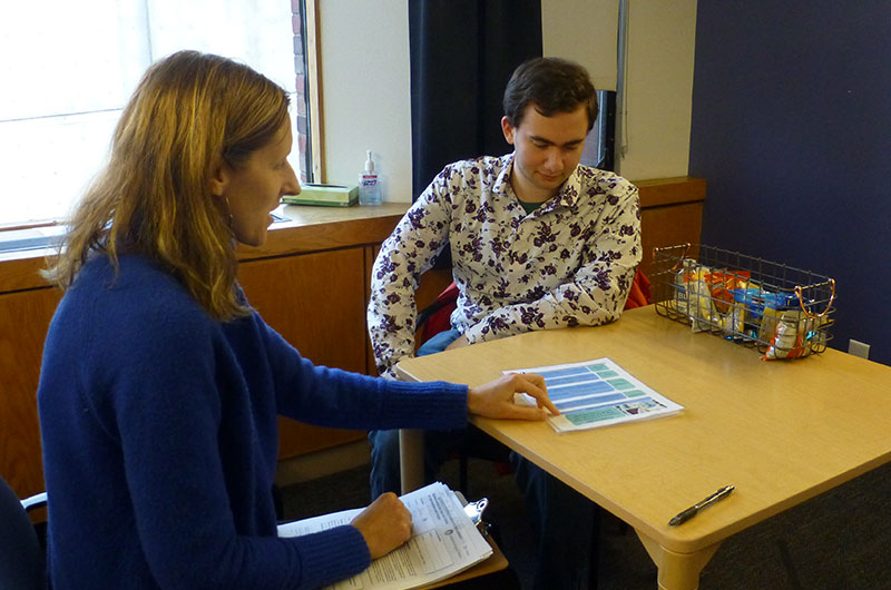 Susan Faja and male adult CRUSH study participant sitting together at a table