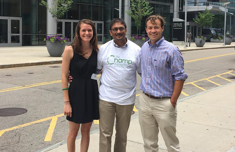 The parents of a boy with Pearson syndrome pose outside of the hospital with their son's doctor