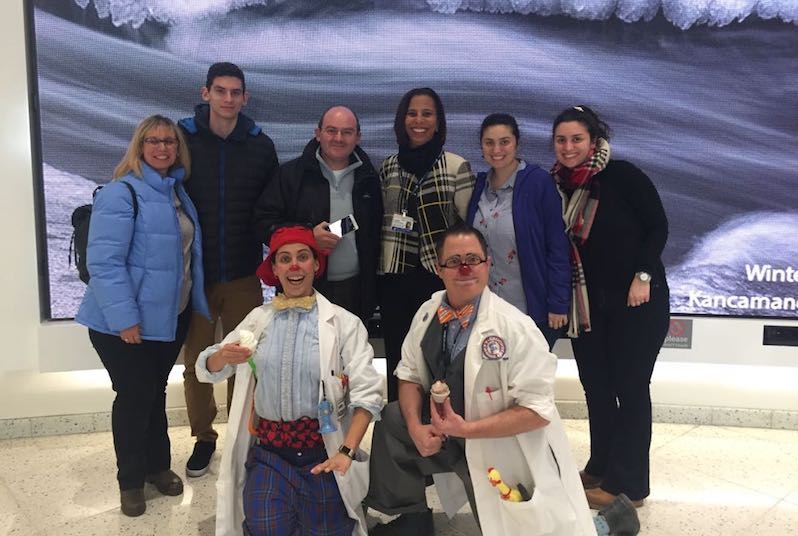 Sue-mei Portugues poses with a family and two clowns in the hospital.