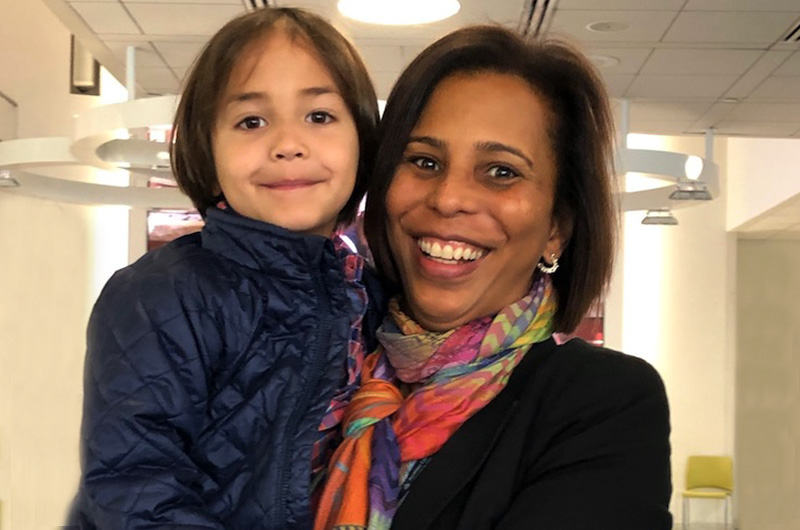 Staff administrator holds a young boy