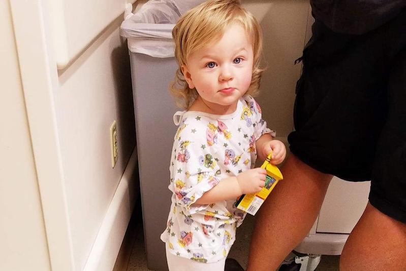 FInley, who had surgery for a cavernous malformation in her brain, holds a box of crayons