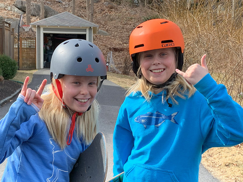two sisters skateboarding while social distancing