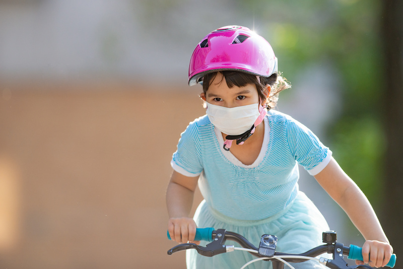Little girl riding her bike.