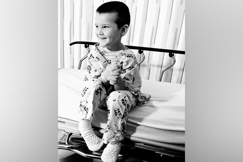black and white photo of curtis, who had a thyroidectomy, in a hospital bed