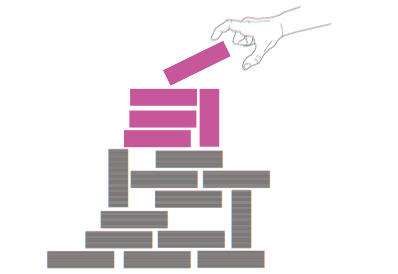hand adding pink blocks atop brown blocks