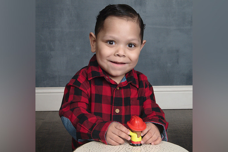 gabby, who has short bowel syndrome, plays with a fireman toy