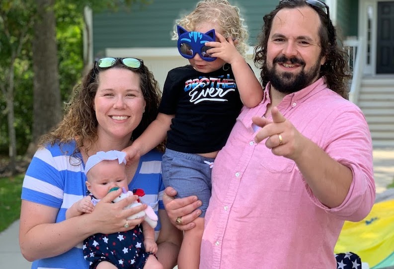 Ruby, who had heart surgery, with her parents and big brother in front of their house.