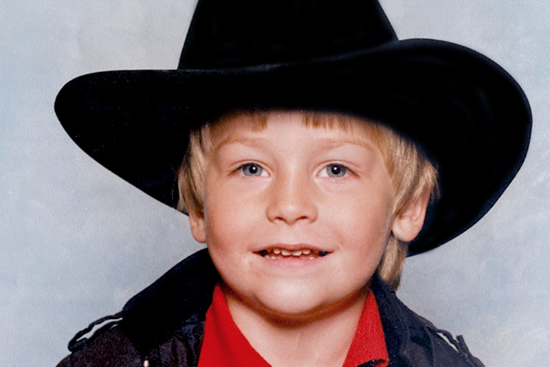 Matt, who has hemophilia A, as a young boy. He is wearing a cowboy cat and red shirt.
